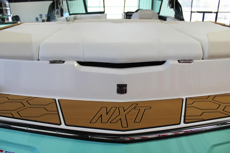 Slide: The Image of 2024 MasterCraft NXT22 boat rear view with teak accents and white upholstery. - 39