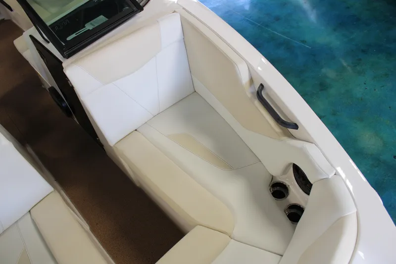 Slide: The Image of 2024 MasterCraft NXT22 boat interior with white and beige seating. - 7