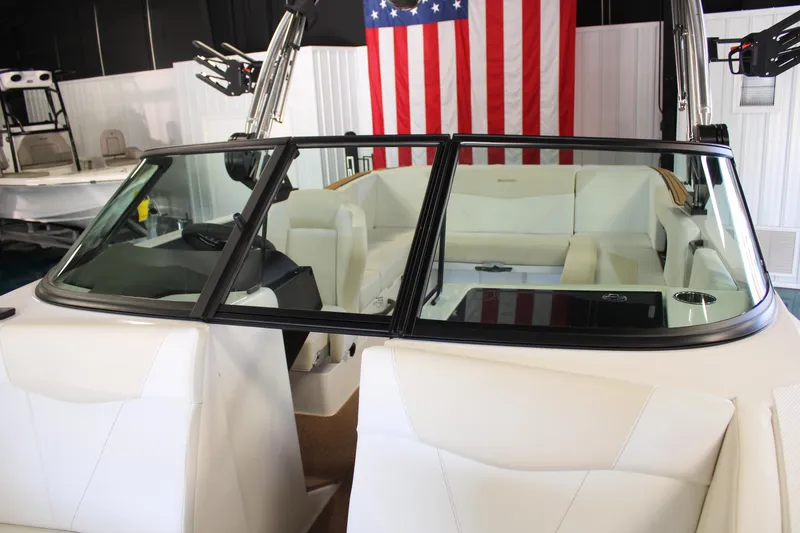 Slide: The Image of 2024 MasterCraft NXT22 boat interior with white seating and American flag background. - 9