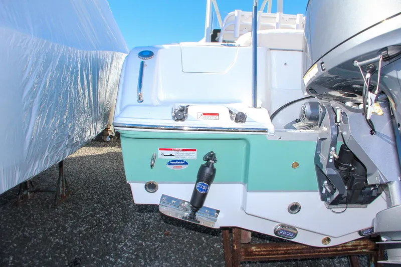 Slide: The Image of 2024 Sea Hunt Ultra 229 boat stern with outboard motor. - 10