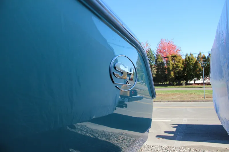 Slide: The Image of 2024 Sea Hunt Ultra 229 boat side view with logo. - 12