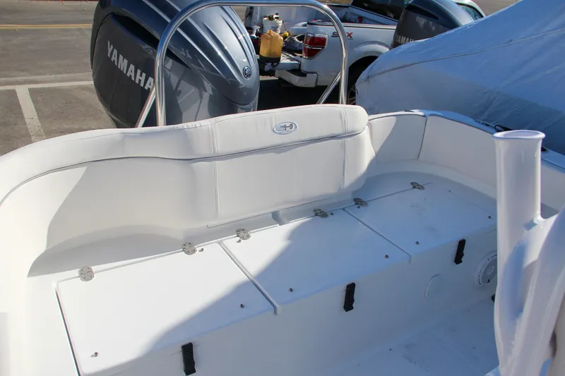 Slide: The Image of 2024 Sea Hunt Ultra 229 boat interior with Yamaha engine in background. - 13