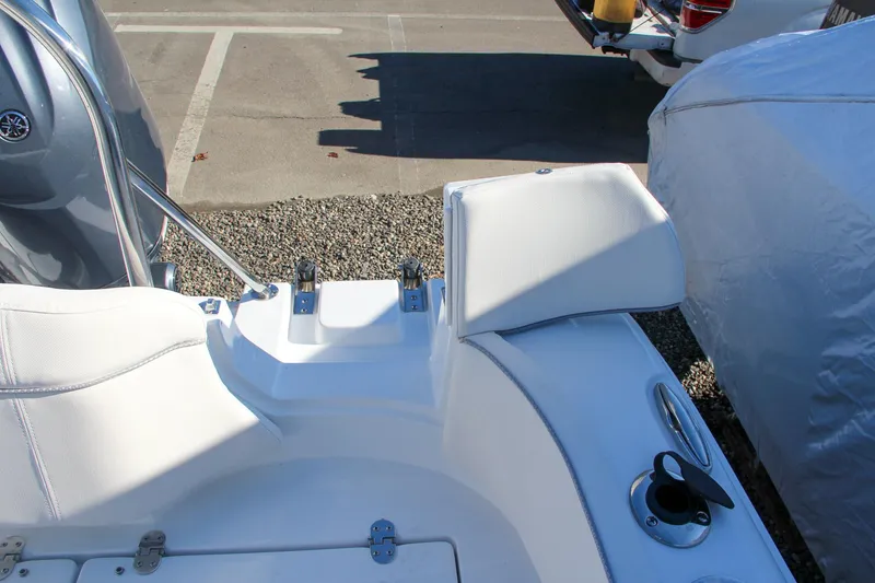 Slide: The Image of 2024 Sea Hunt Ultra 229 boat interior with white seating and cup holder. - 15