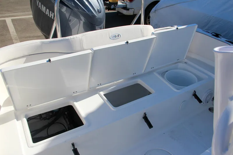 Slide: The Image of 2024 Sea Hunt Ultra 229 boat storage compartments and seating area. - 16