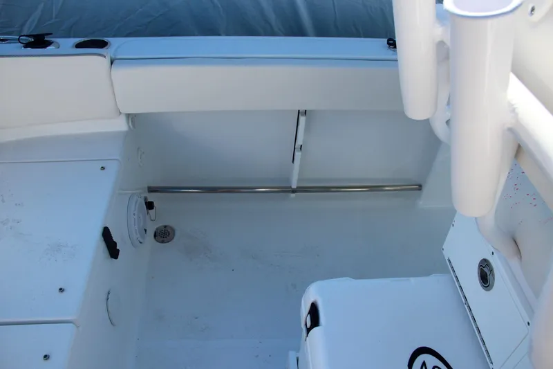 Slide: The Image of 2024 Sea Hunt Ultra 229 boat interior, white seating and storage compartments. - 21