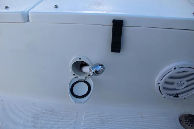 Slide: The Image of 2024 Sea Hunt Ultra 229 boat deck with speaker and hose connection. - 23