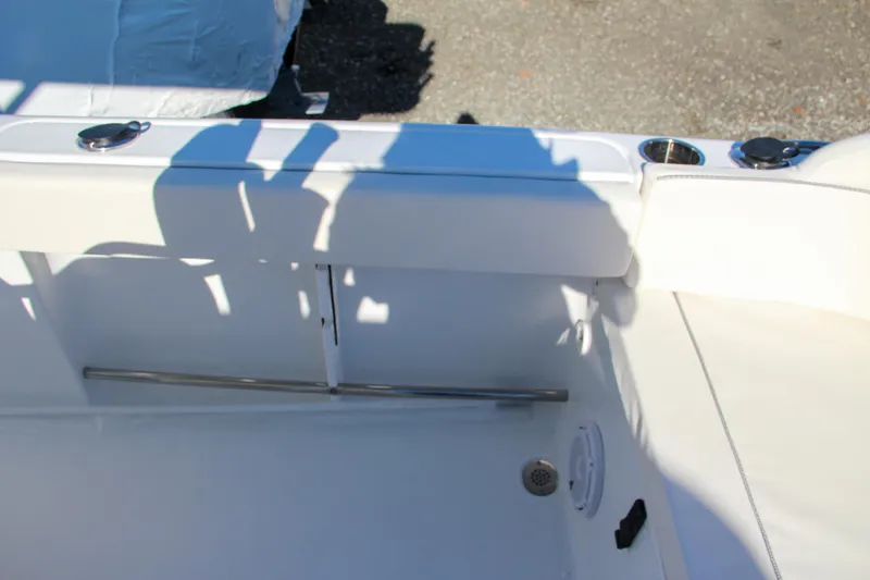 Slide: The Image of 2024 Sea Hunt Ultra 229 boat interior detail with white seating and stainless steel fixtures. - 24