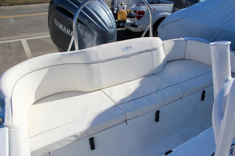 Slide: The Image of 2024 Sea Hunt Ultra 229 boat with Yamaha engine and white cushioned seating. - 25