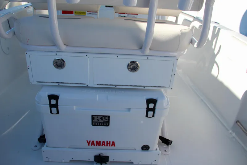 Slide: The Image of 2024 Sea Hunt Ultra 229 boat interior with storage drawers and Yamaha cooler. - 27