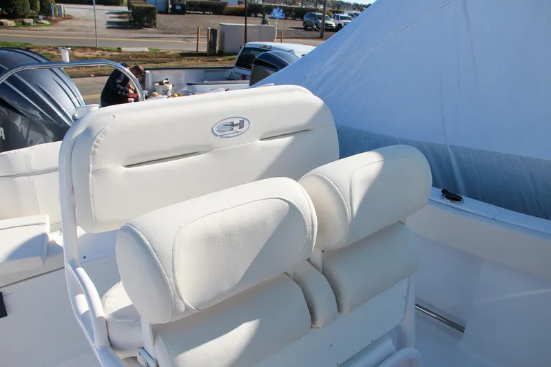 Slide: The Image of 2024 Sea Hunt Ultra 229 boat with white cushioned seating. - 33