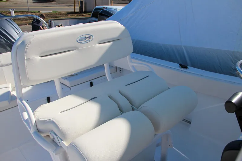 Slide: The Image of 2024 Sea Hunt Ultra 229 boat seating with white cushioned seats. - 34