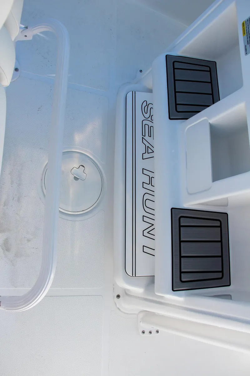 Slide: The Image of 2024 Sea Hunt Ultra 229 boat deck with logo and storage compartments. - 36