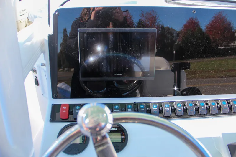 Slide: The Image of 2024 Sea Hunt Ultra 229 boat dashboard with Garmin display and control panel. - 38