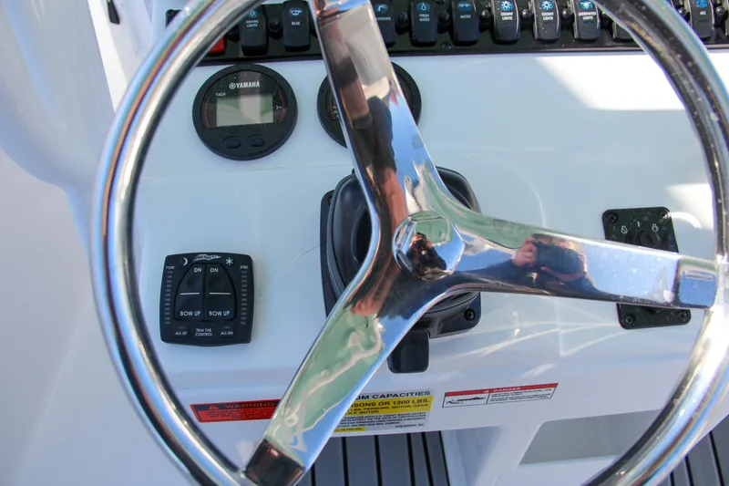 Slide: The Image of 2024 Sea Hunt Ultra 229 boat steering wheel and control panel. - 39