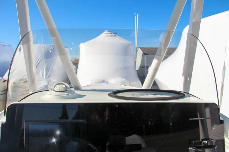 Slide: The Image of 2024 Sea Hunt Ultra 229 boat dashboard with compass and navigation equipment. - 42