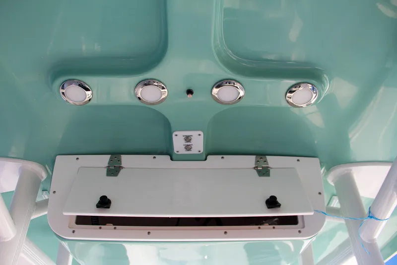 Slide: The Image of 2024 Sea Hunt Ultra 229 boat overhead console with storage and lights. - 43