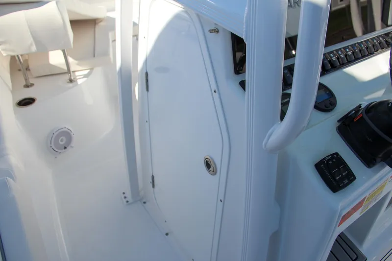 Slide: The Image of 2024 Sea Hunt Ultra 229 boat interior, featuring console and seating area. - 46