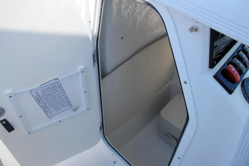 Slide: The Image of 2024 Sea Hunt Ultra 229 interior cabin with open door. - 47