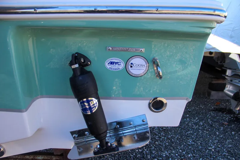 Slide: The Image of 2024 Sea Hunt Ultra 229 boat transom with trim tab and certification stickers. - 6