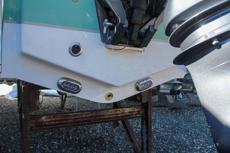 Slide: The Image of 2024 Sea Hunt Ultra 229 boat stern with underwater lights and outboard motor. - 8