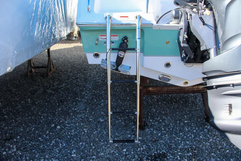 Slide: The Image of 2024 Sea Hunt Ultra 229 boat with extended swim ladder. - 9