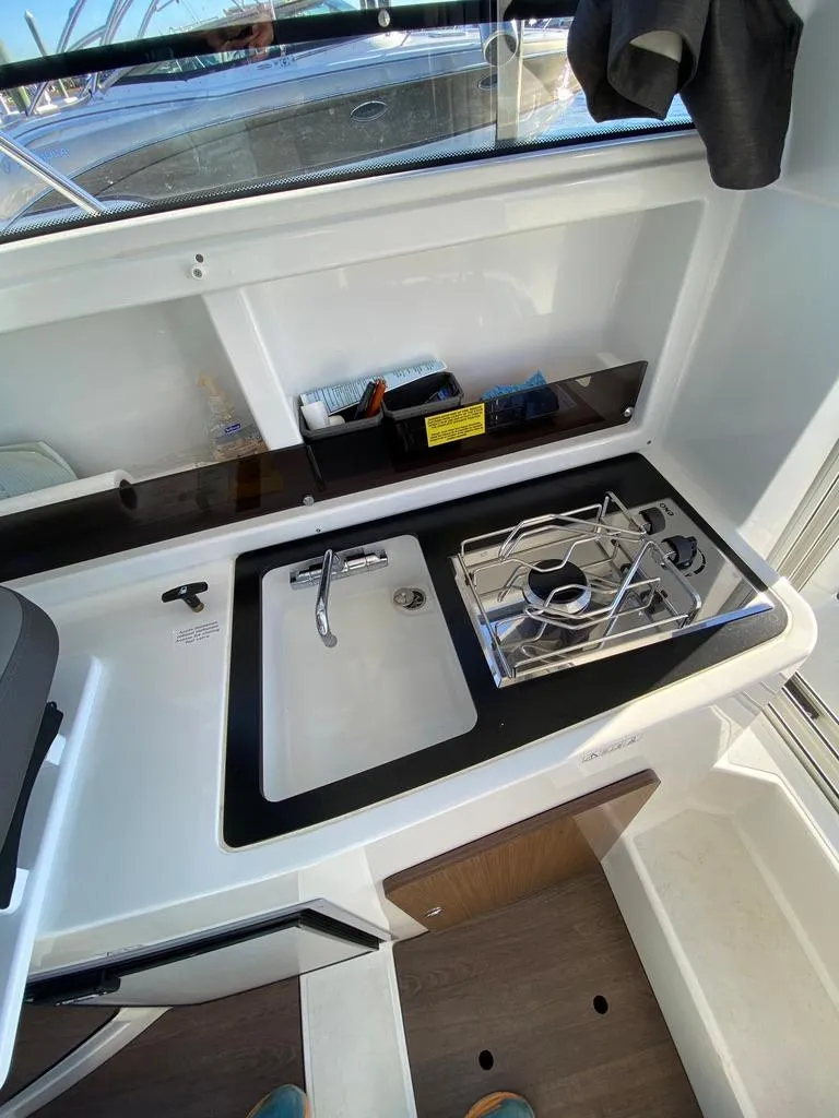 Slide: The Image of 2021 Beneteau Antares 23 boat kitchen with sink and stove - 10