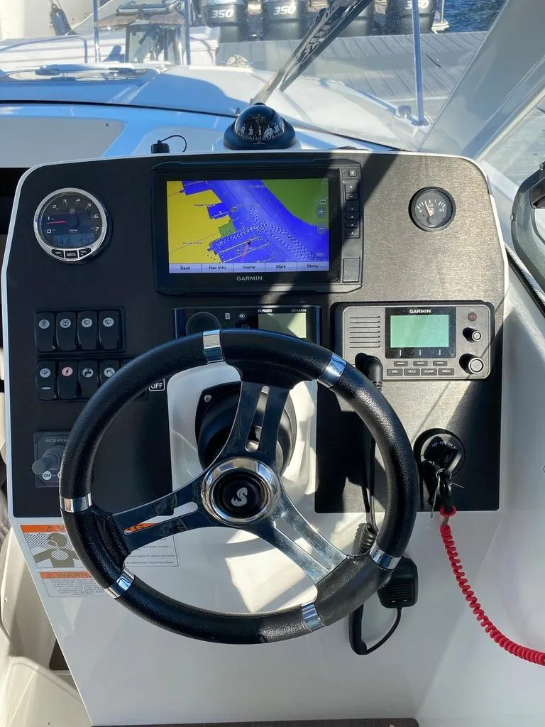 Slide: The Image of 2021 Beneteau Antares 23 helm with navigation and control systems. - 14