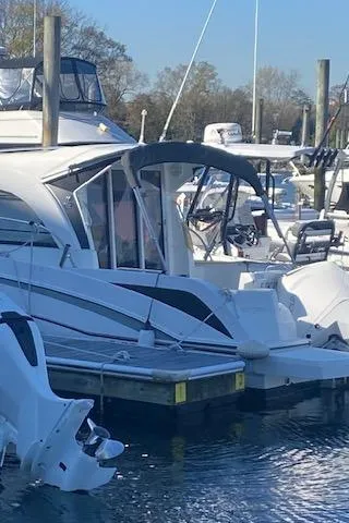 Slide: The Image of Beneteau Antares 23 2021 model docked at a marina. - 2