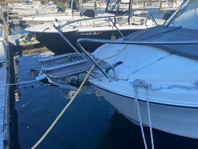 Slide: The Image of 2021 Beneteau Antares 23 docked at marina, front view with anchor and ropes. - 3
