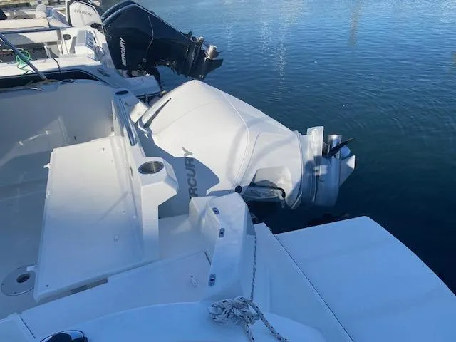 Slide: The Image of 2021 Beneteau Antares 23 with Mercury outboard engine docked at marina. - 4
