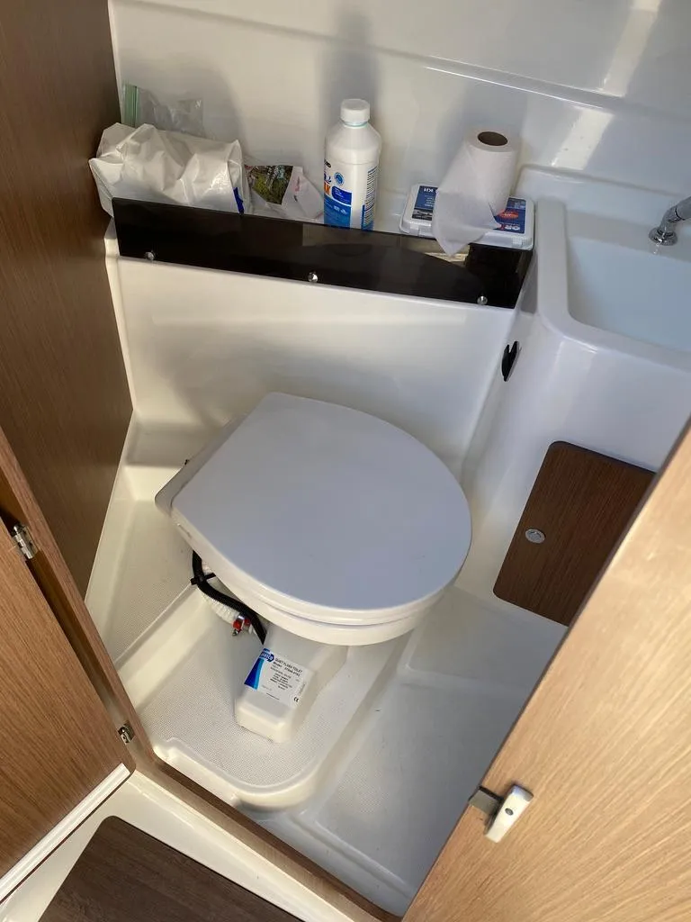 Slide: The Image of 2021 Beneteau Antares 23 boat bathroom with toilet and sink. - 5