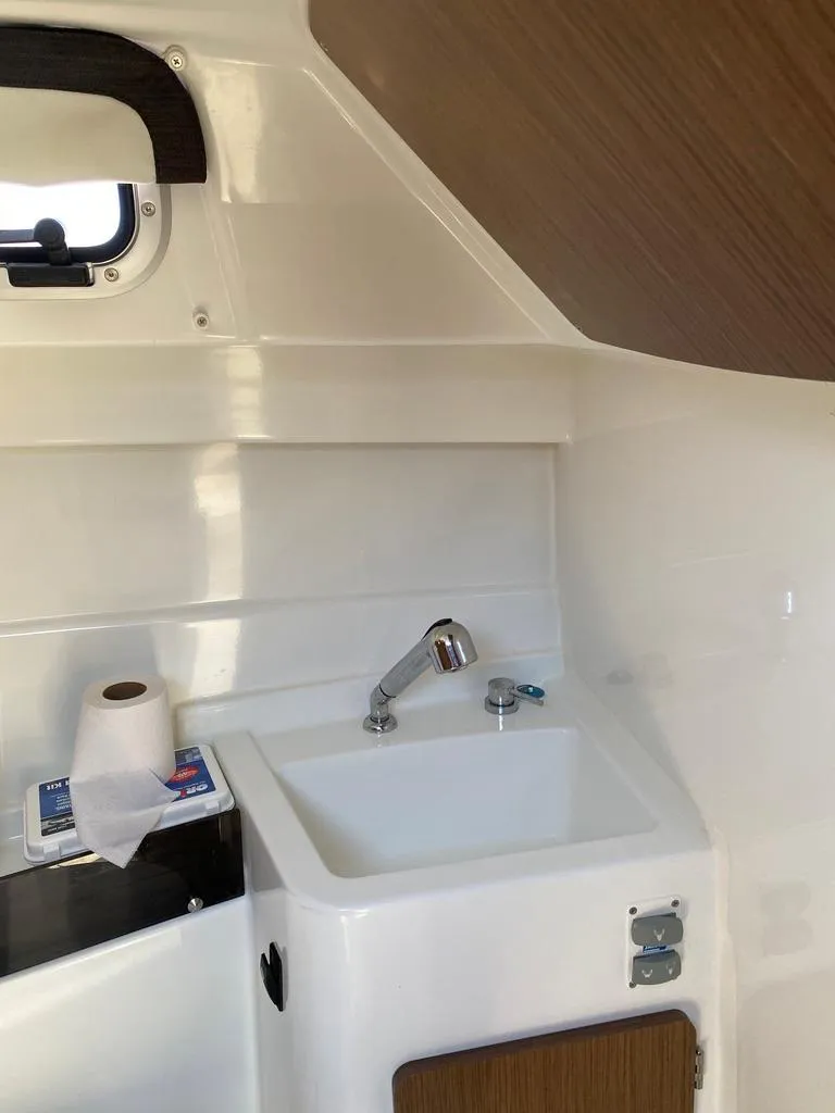 Slide: The Image of 2021 Beneteau Antares 23 boat interior sink and storage area. - 6