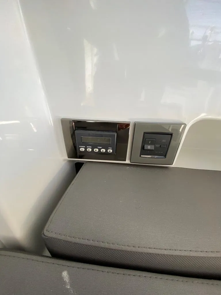 Slide: The Image of Control panel and switches inside a 2021 Beneteau Antares 23 boat. - 9