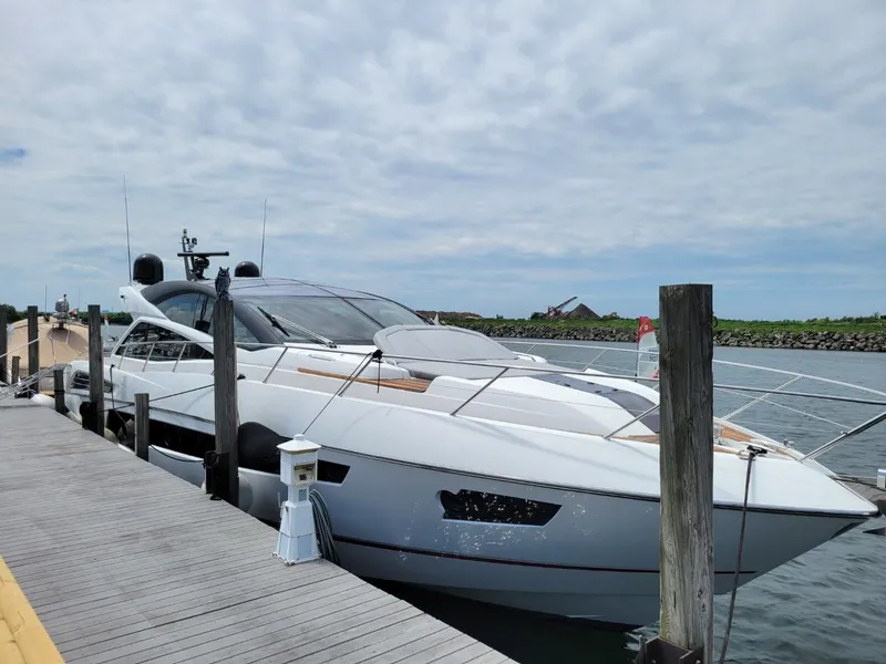 Slide: The Image of 2014 Sunseeker 68 Predator yacht docked at marina on a cloudy day. - 1