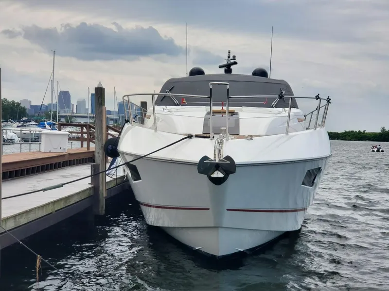 Slide: The Image of 2014 Sunseeker 68 Predator yacht docked at marina with city skyline in background. - 10