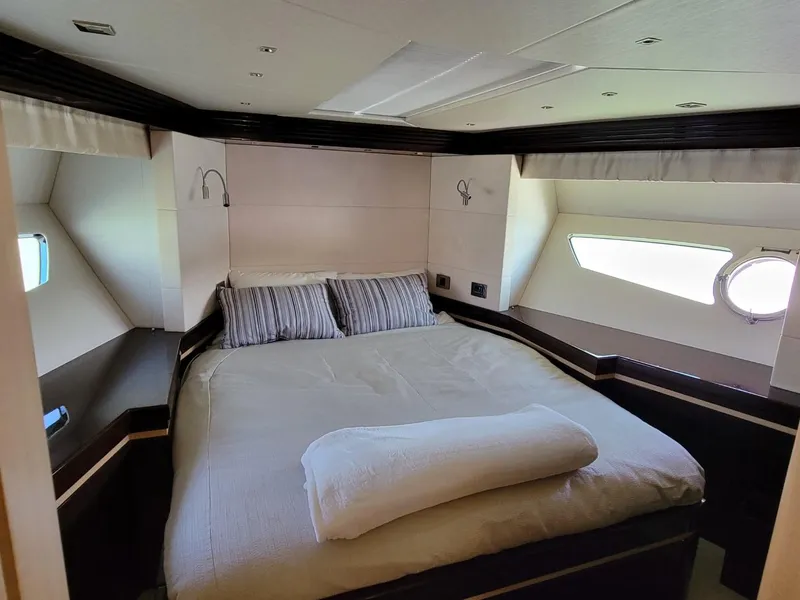 Slide: The Image of Luxurious bedroom in a 2014 Sunseeker 68 Predator yacht with modern decor. - 24