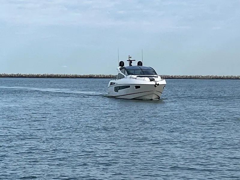 Slide: The Image of 2014 Sunseeker 68 Predator yacht cruising on calm waters. - 30