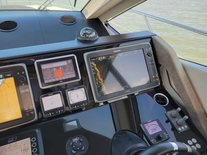Slide: The Image of Control panel of a 2014 Sunseeker 68 Predator yacht with navigation screens. - 4