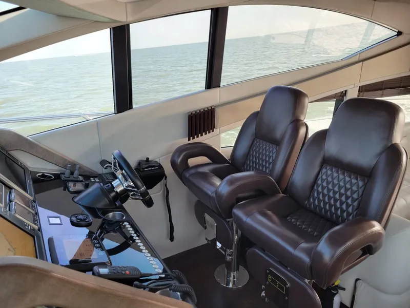 Slide: The Image of Interior helm of 2014 Sunseeker 68 Predator yacht with leather seats and ocean view. - 6