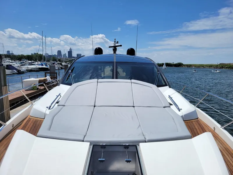 Slide: The Image of 2014 Sunseeker 68 Predator yacht docked at marina with city skyline in background. - 9