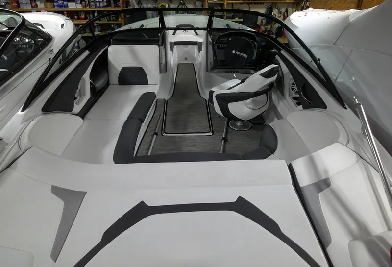 Slide: The Image of 2023 Monterey 224FS boat interior with sleek seating and modern dashboard. - 10