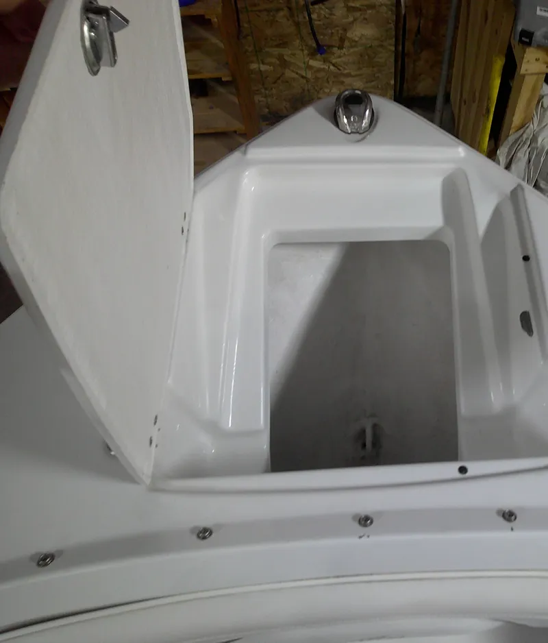 Slide: The Image of 2023 Monterey 224FS boat storage compartment with open hatch. - 2