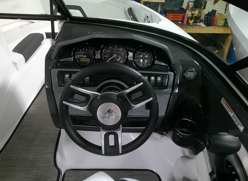 Slide: The Image of 2023 Monterey 224FS boat dashboard with steering wheel and instrument panel. - 4