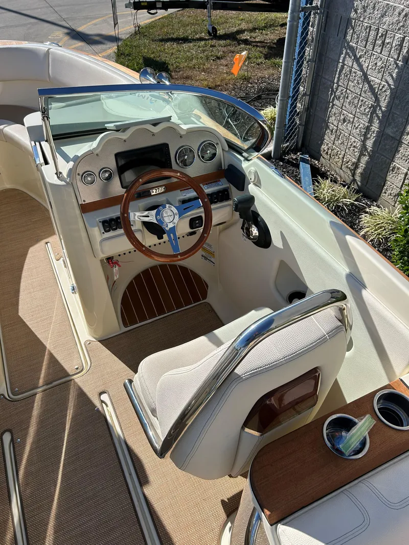 Slide: The Image of 2020 Chris-Craft Launch 27 boat interior with steering wheel and dashboard. - 10