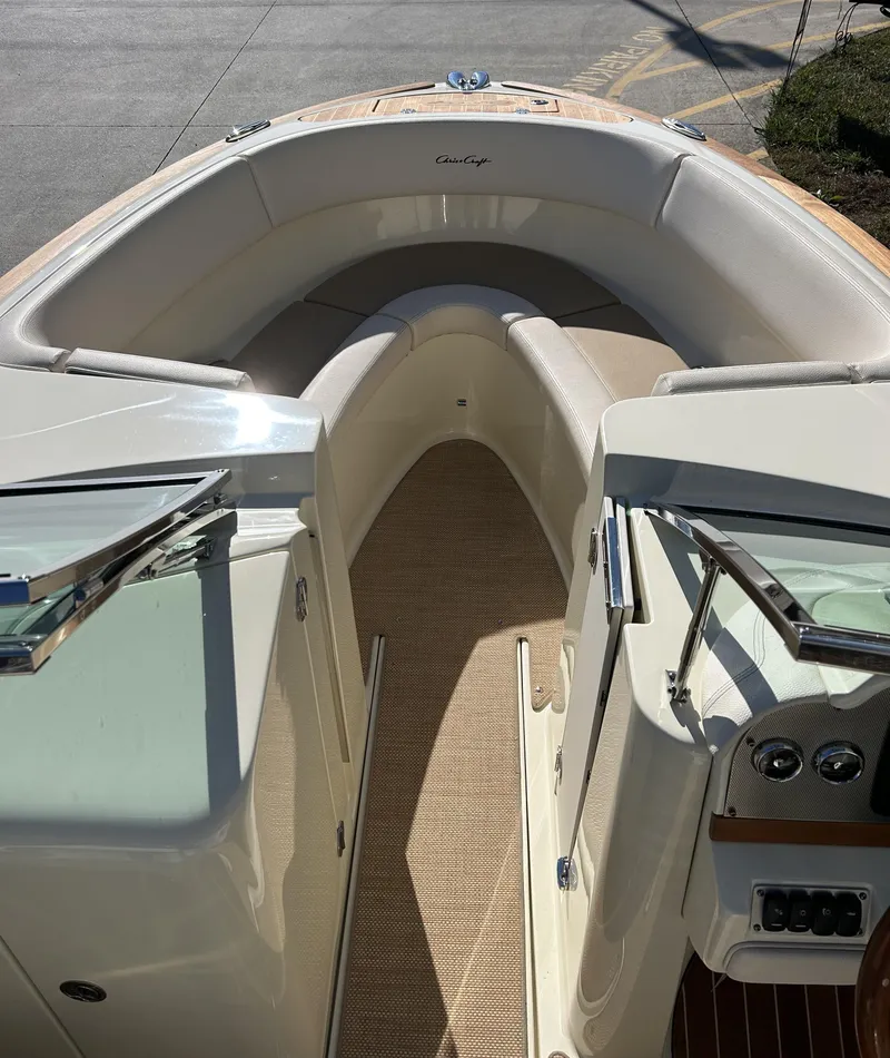 Slide: The Image of 2020 Chris-Craft Launch 27 boat interior with cushioned seating and control panel. - 7