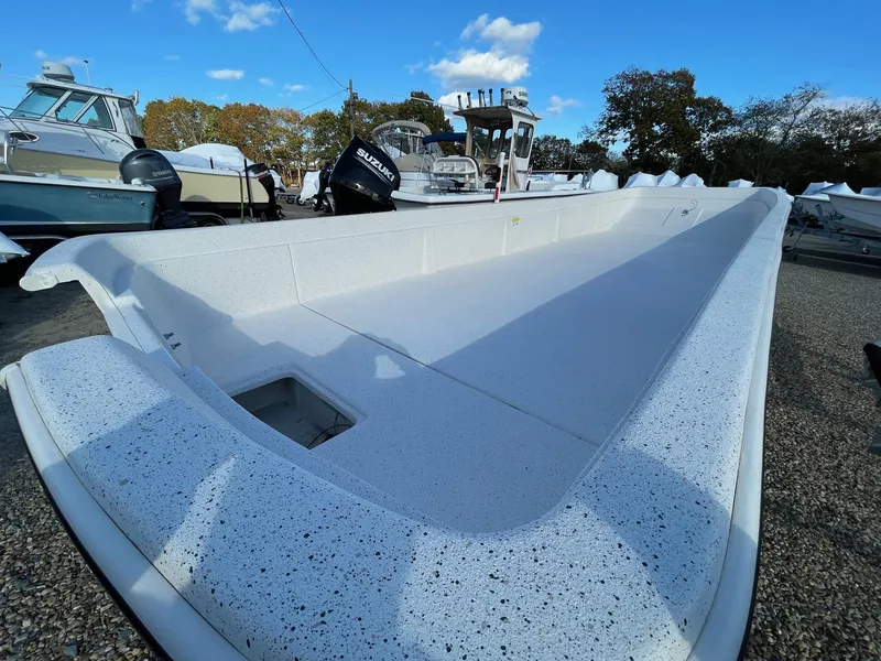 Slide: The Image of 2024 Carolina Skiff e24 DLX boat on display in a marina. - 3