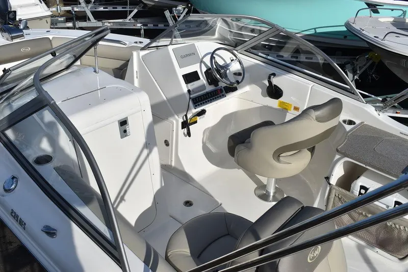 Slide: The Image of 2024 Key West 239 DFS boat interior with steering wheel and seating. - 20