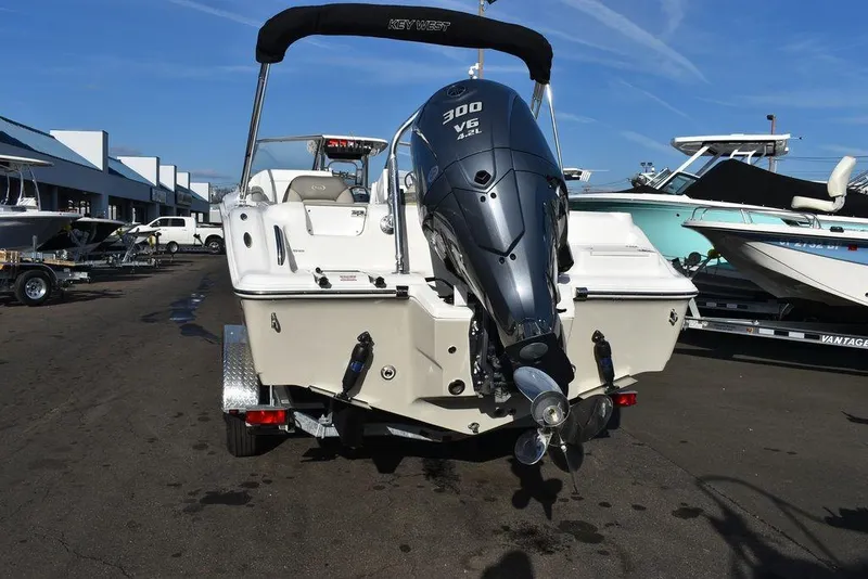 Slide: The Image of 2024 Key West 239 DFS boat with Yamaha 300 V6 engine, parked outdoors. - 24