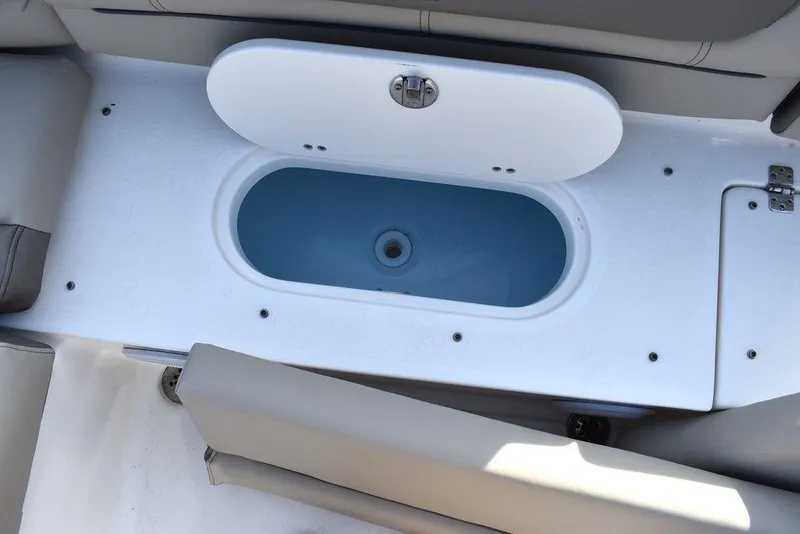 Slide: The Image of 2024 Key West 239 DFS boat livewell with open lid, showcasing interior design. - 31