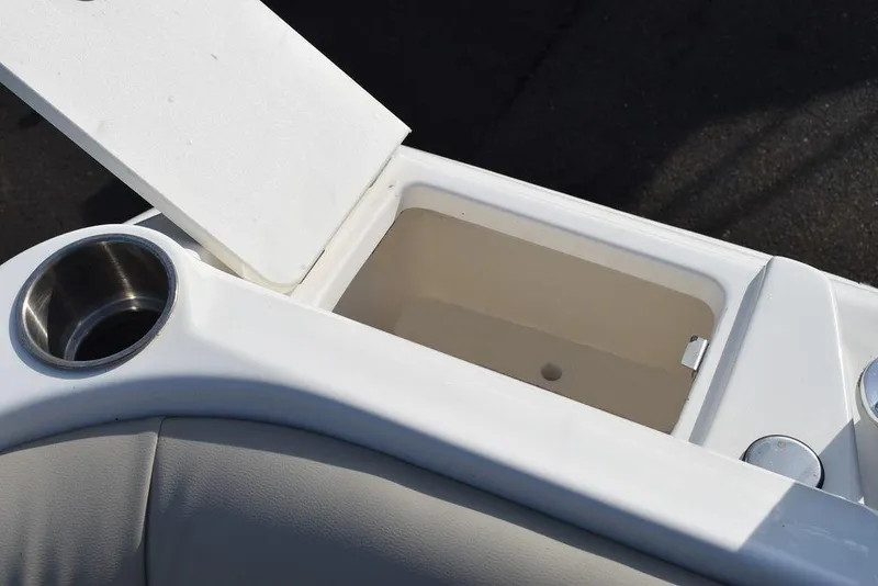Slide: The Image of 2024 Key West 239 DFS boat interior with open storage compartment and cup holder. - 33